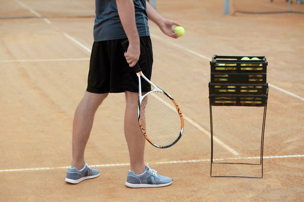Young man playing tennis on court - Photo, Image