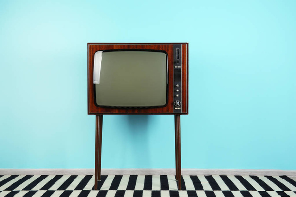 Vintage television near color wall - Photo, Image