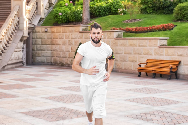 Sporty man running outdoors - Foto, immagini
