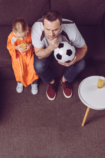 daughter and father watching football game  - Photo, Image