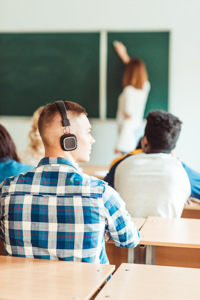 student listening music on lecture - Photo, Image