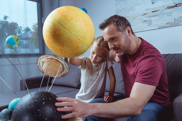 Father showing daughter planets  - Photo, Image