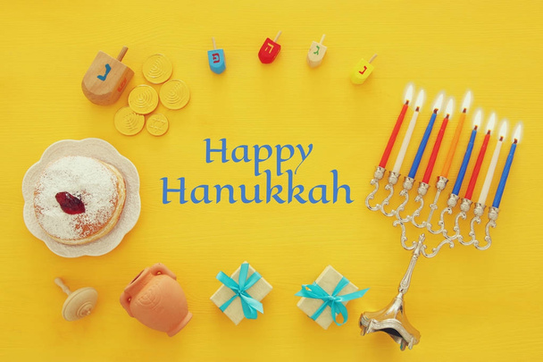 Top view image of jewish holiday Hanukkah background with traditional spinnig top, menorah (traditional candelabra) - Photo, Image