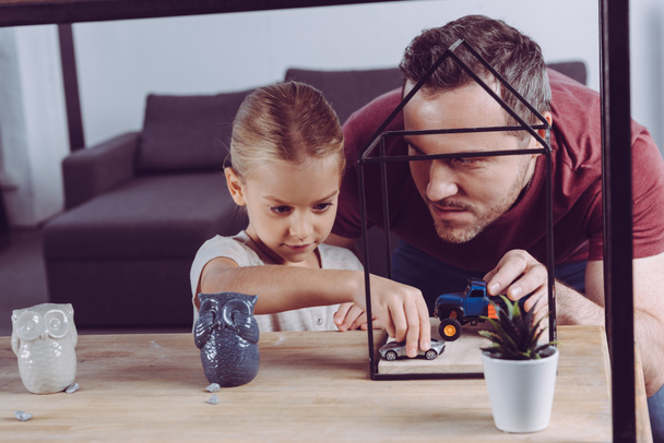 father and daughter playing car toys  - Foto, afbeelding
