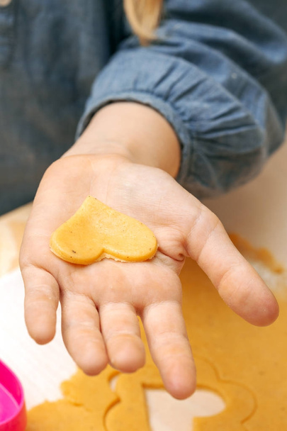 little girl makes a cookie in the kitchen  - Φωτογραφία, εικόνα