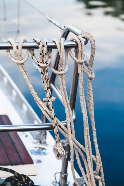 Ropes tied a noose hanging on the fence yacht - Photo, image