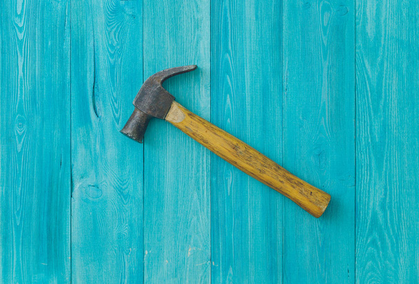 old hammer on a blue wooden background close-up - Photo, Image