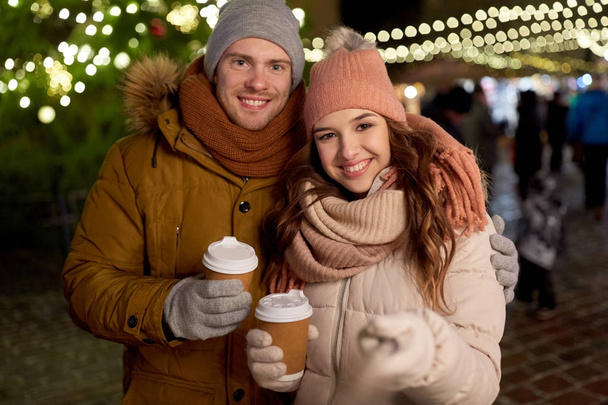 couple with coffee taking selfie at christmas - Фото, зображення