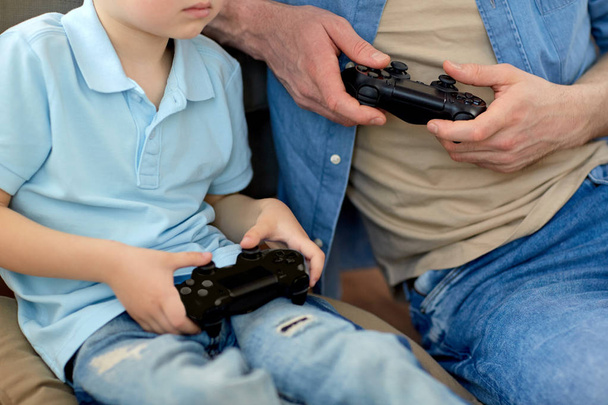close up of father and son playing video game - Valokuva, kuva