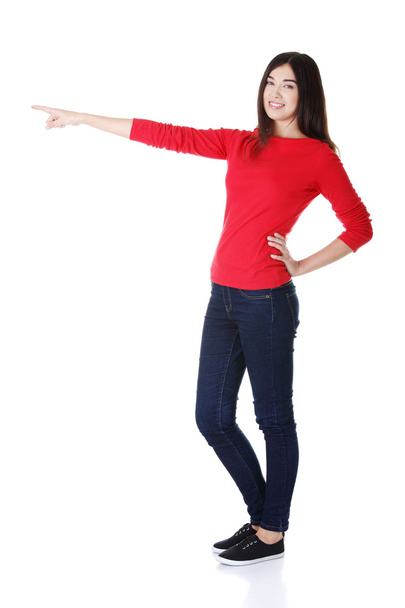 Happy , excited young woman pointing on copy space - Photo, image