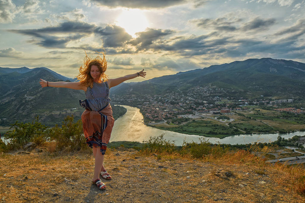 Happy young woman near Jvari Monastery of Georgia - Фото, изображение