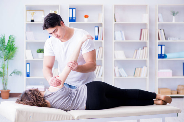 Young doctor chiropractor massaging female patient woman - Photo, image