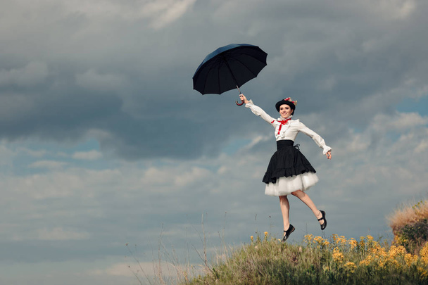 Retro Woman with Umbrella Up in The Air in Fantasy Portrait - Фото, зображення