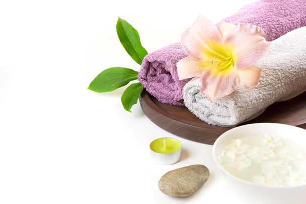 Spa setting of towel, flower isolated on white background with copy space. - Fotografie, Obrázek