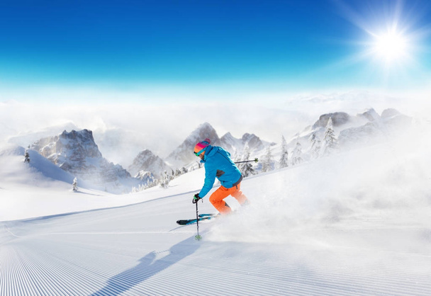 Young man skier running down the slope in Alpine mountains - Photo, Image