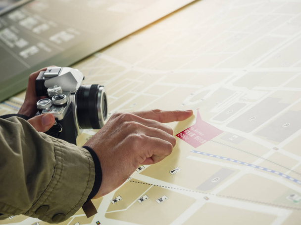 People hand point on map Tourist travel with camera - Photo, image