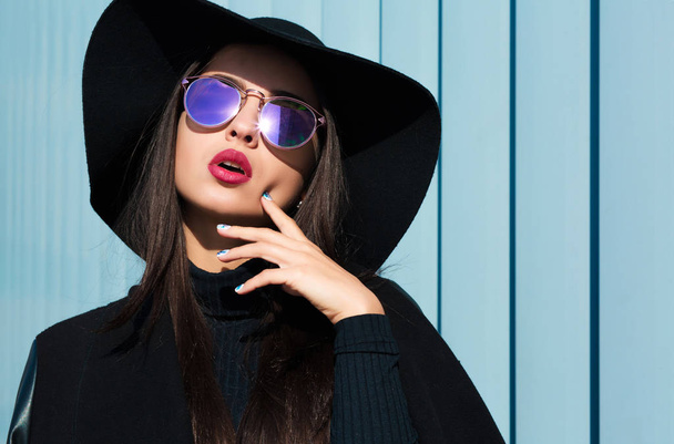 Luxurious brunette lady wears black hat and sunglasses.Woman pos - Photo, Image