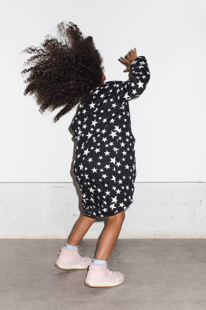 Black kid in dress dancing in studio - Valokuva, kuva