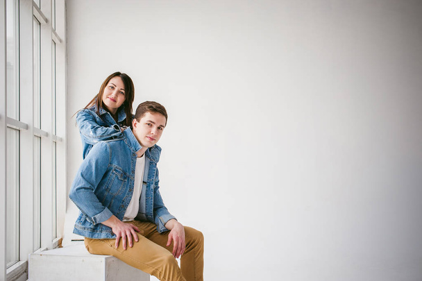 young couple, man and woman in trendy jeans clothes, studio shot on white background - Foto, Imagem
