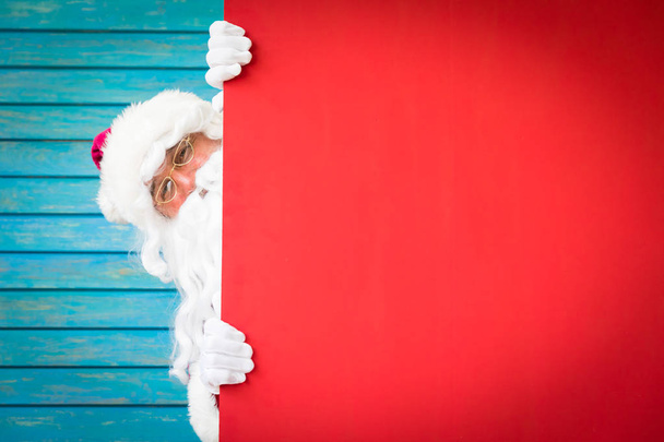 Santa Claus holding red blank banner - Фото, зображення