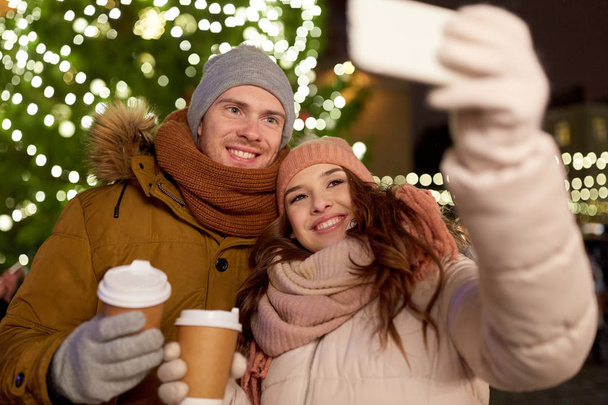 couple with coffee taking selfie at christmas - Фото, зображення