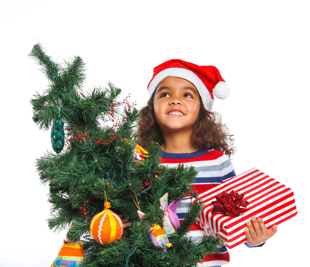 Little girl in Santa's hat with gift box - Fotó, kép