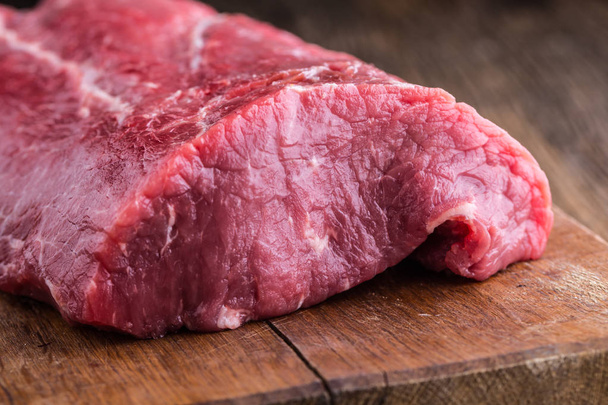 Beef Steak. Raw beef steak. Big Rib Eye steak on wooden board - Фото, изображение