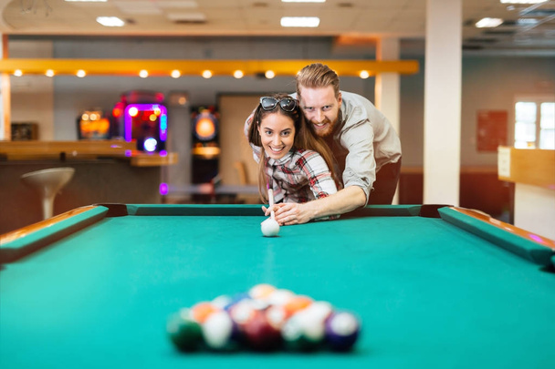 Couple flirting while playing snooker - Valokuva, kuva