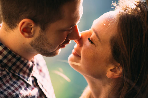 Love is in the air. Beautiful happy couple kissing softly  - Фото, изображение