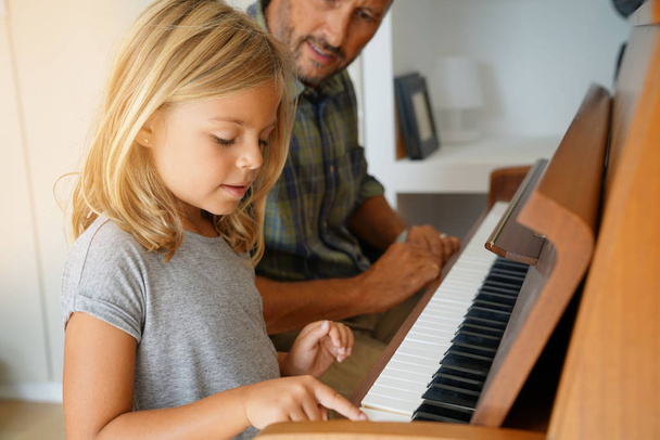  girl with teacher playing piano - Φωτογραφία, εικόνα