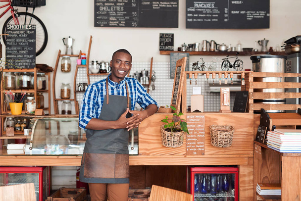 entrepreneur leaning against counter of cafe  - Фото, зображення