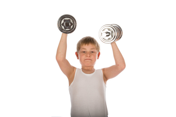 Young boy exercising with two dumbbells - Фото, зображення