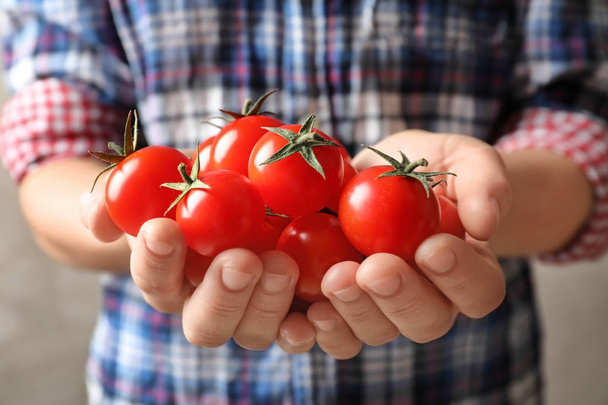 Woman holding many ripe cherry tomatoes - Zdjęcie, obraz