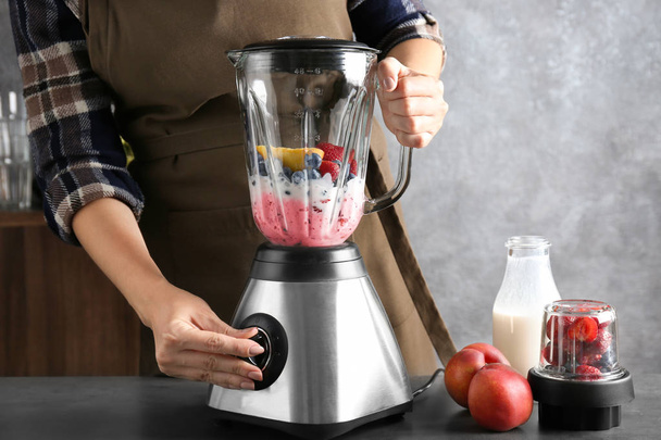 Young woman preparing smoothie  - Photo, Image