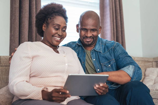 Smiling couple using digital tablet - Photo, image