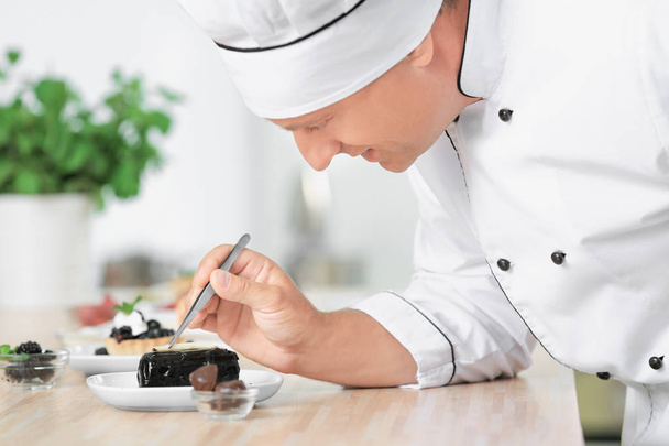 Male chef cooking dessert in kitchen - Photo, image