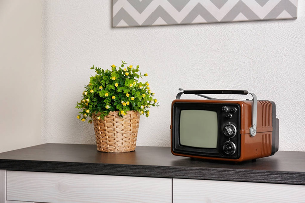 Old vintage TV on cupboard - Fotó, kép