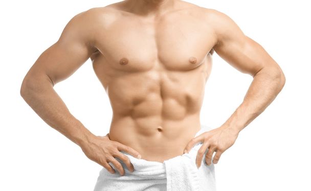 Muscular man wrapped in towel, on white background - Photo, Image