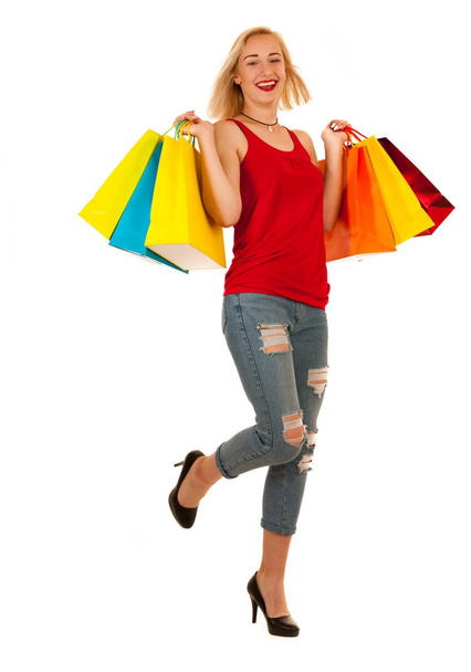 Attractive blonde young woman with shopping bags isolated - Foto, afbeelding