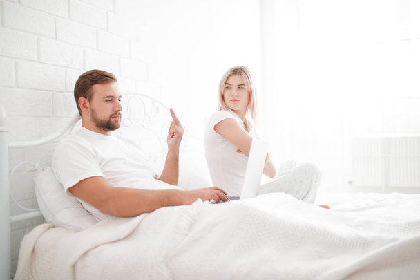 Sensual young couple together in bed. Angry couple in bedroom on a white background. - Foto, afbeelding