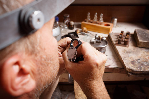 Close-up jeweler working. Craftsman making jewelry on a workshop background. Accessory making concept. - Valokuva, kuva