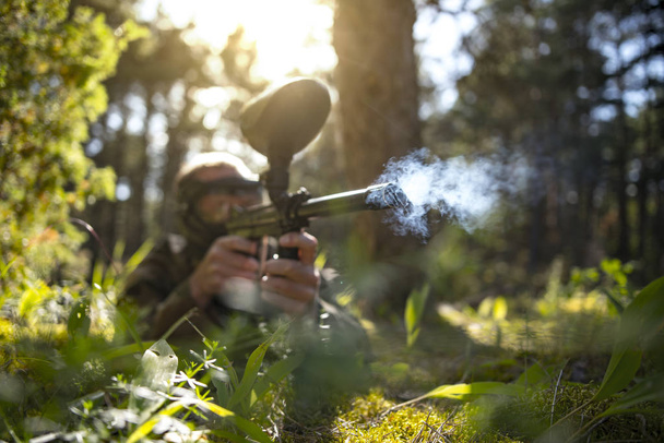 Nahaufnahme von Rauch aus einer Paintballpistole im Wald - Foto, Bild