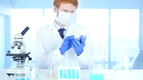 Scientist Using Smartphone in Laboratory for Browsing - Felvétel, videó
