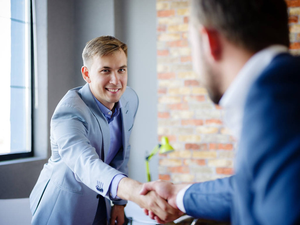 Men shaking hands. Confident businessman shaking hands with each other. - Fotó, kép