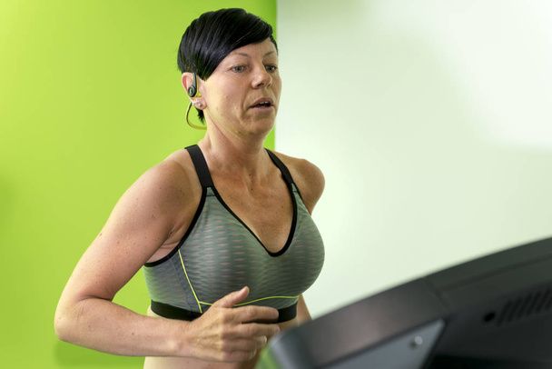 Pixie-Haired Woman Working Out on a Treadmill - Photo, Image
