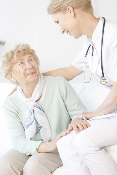 Senior woman talking to doctor - Photo, image