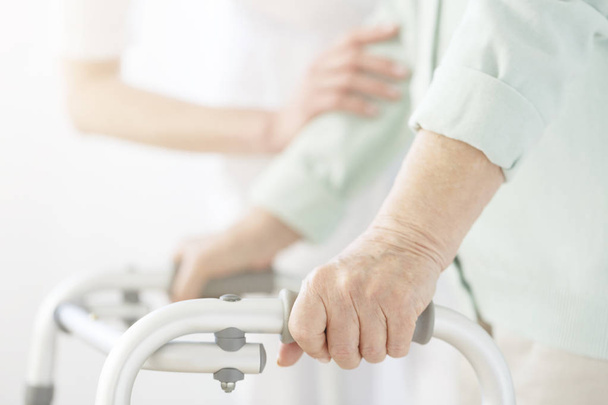 Nurse supporting elderly person - Valokuva, kuva