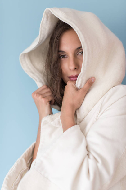 woman in a white coat with hood  - Фото, изображение