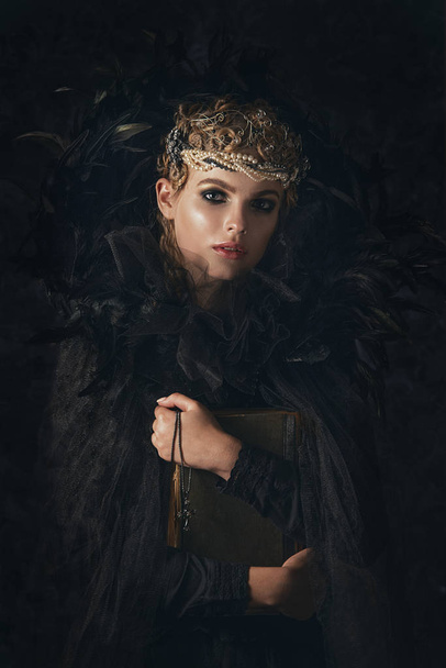 Queen of darkness in black fantasy costume on dark gothic background. High fashion beauty model with dark makeup. - Fotografie, Obrázek