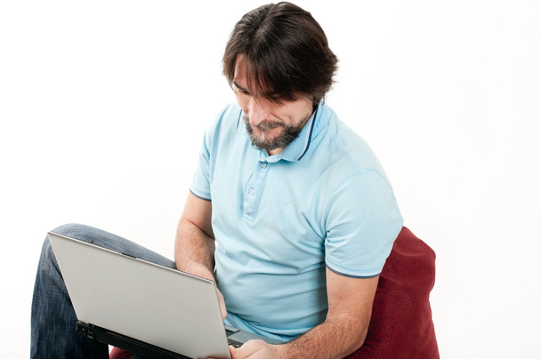 A man with a laptop on a light background - Фото, зображення